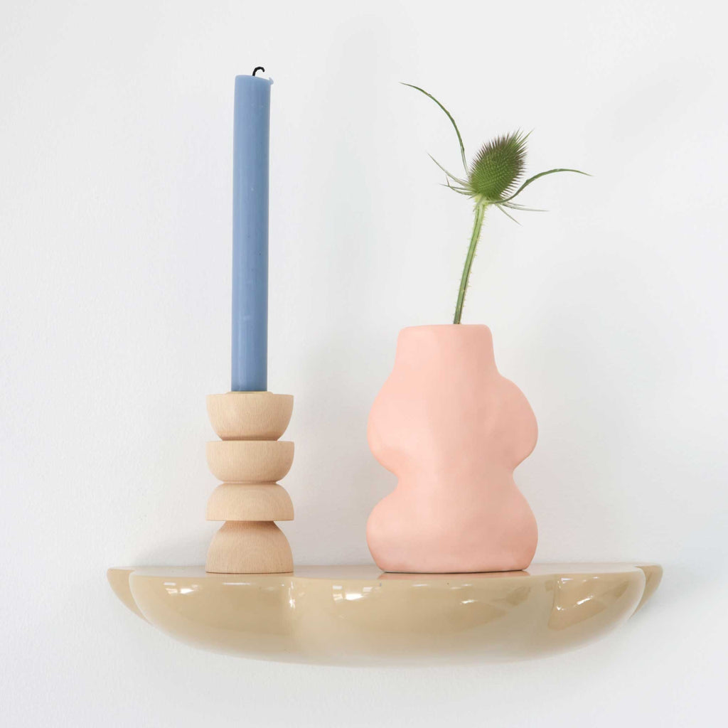 elegant pink ceramic vase on a marble tabletop, morning light highlighting its flowing handmade lines
