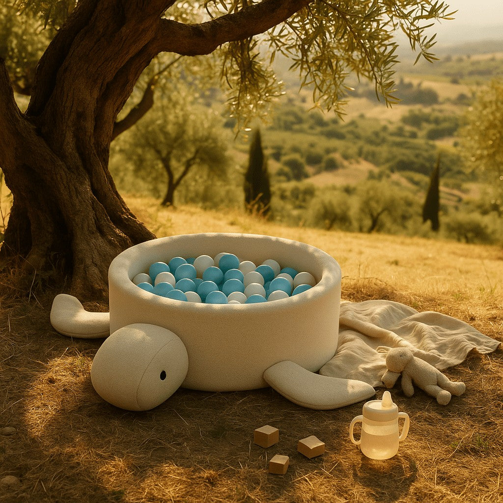 a soft beige boucle turtle ball pit for babies in a cozy, sunlit nursery setting