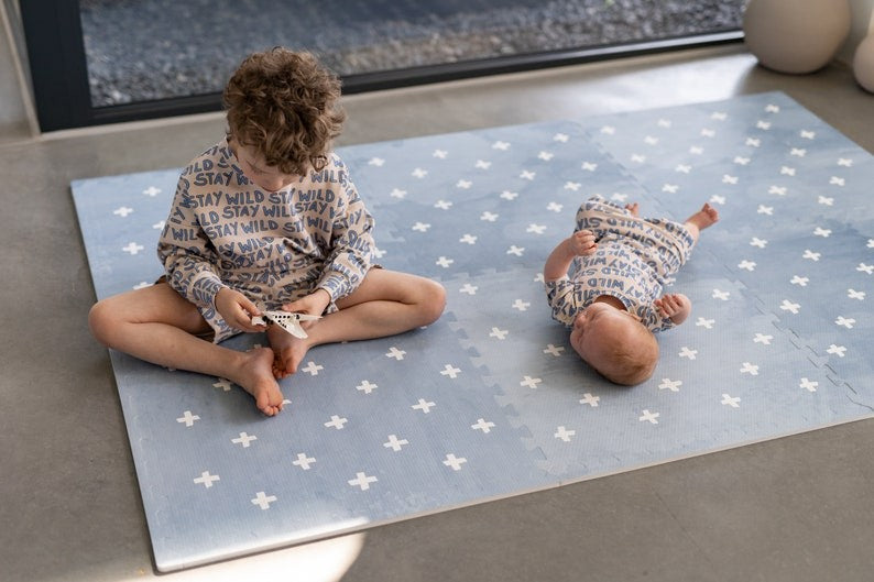 a playful close-up of the cross azure foam mat, showing its puzzle-piece edges and soft texture