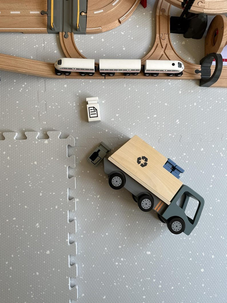 a soft dove grey baby playmat in warm morning light, perfect for a stylish nursery