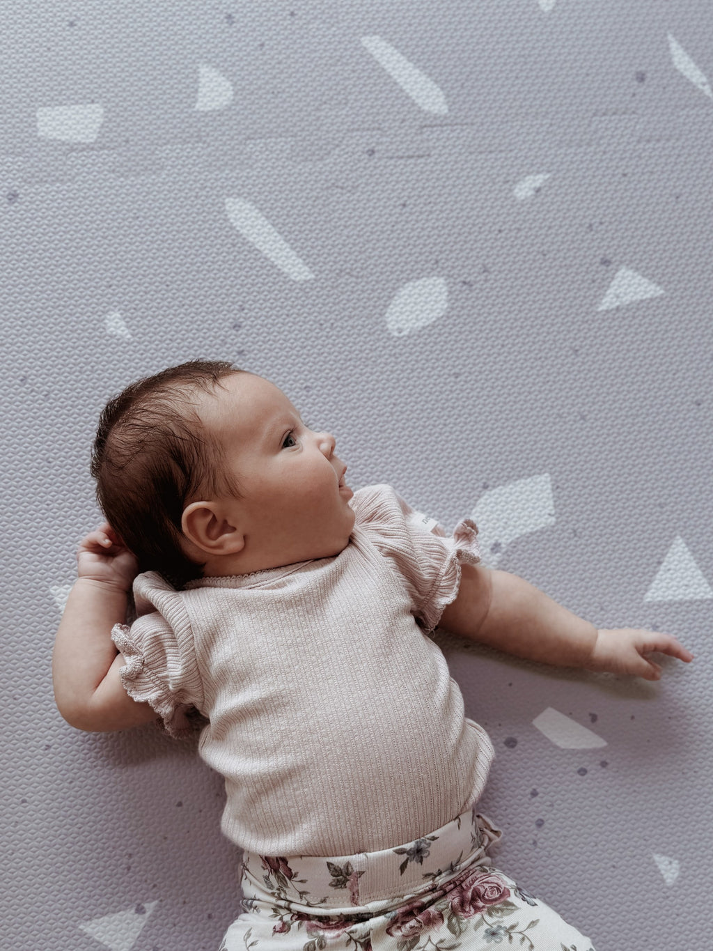 close-up of a lavender terrazzo foam playmat tile showing its 1.2 cm thickness and non-slip texture