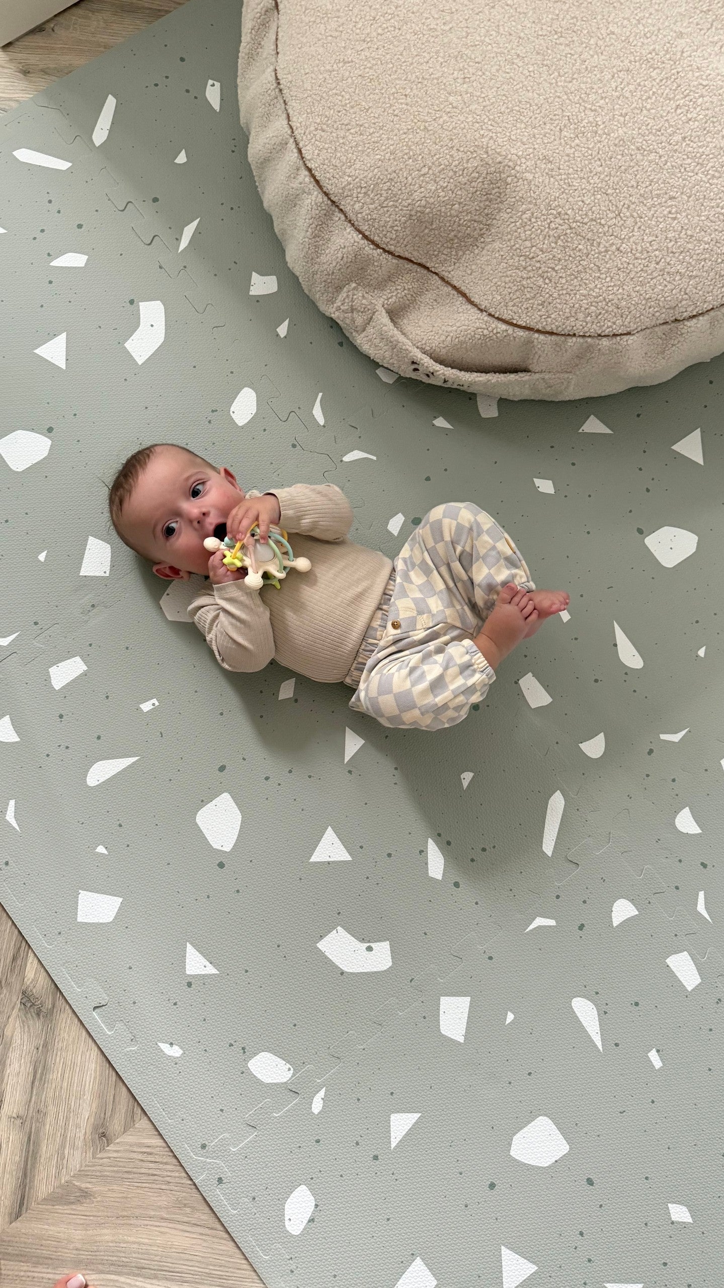 bold sage terrazzo foam playmat for babies on a clean minimalist background