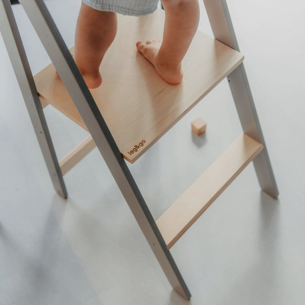 foldable kitchen helper tower with safety rail in a warm, sunlit kitchen setting