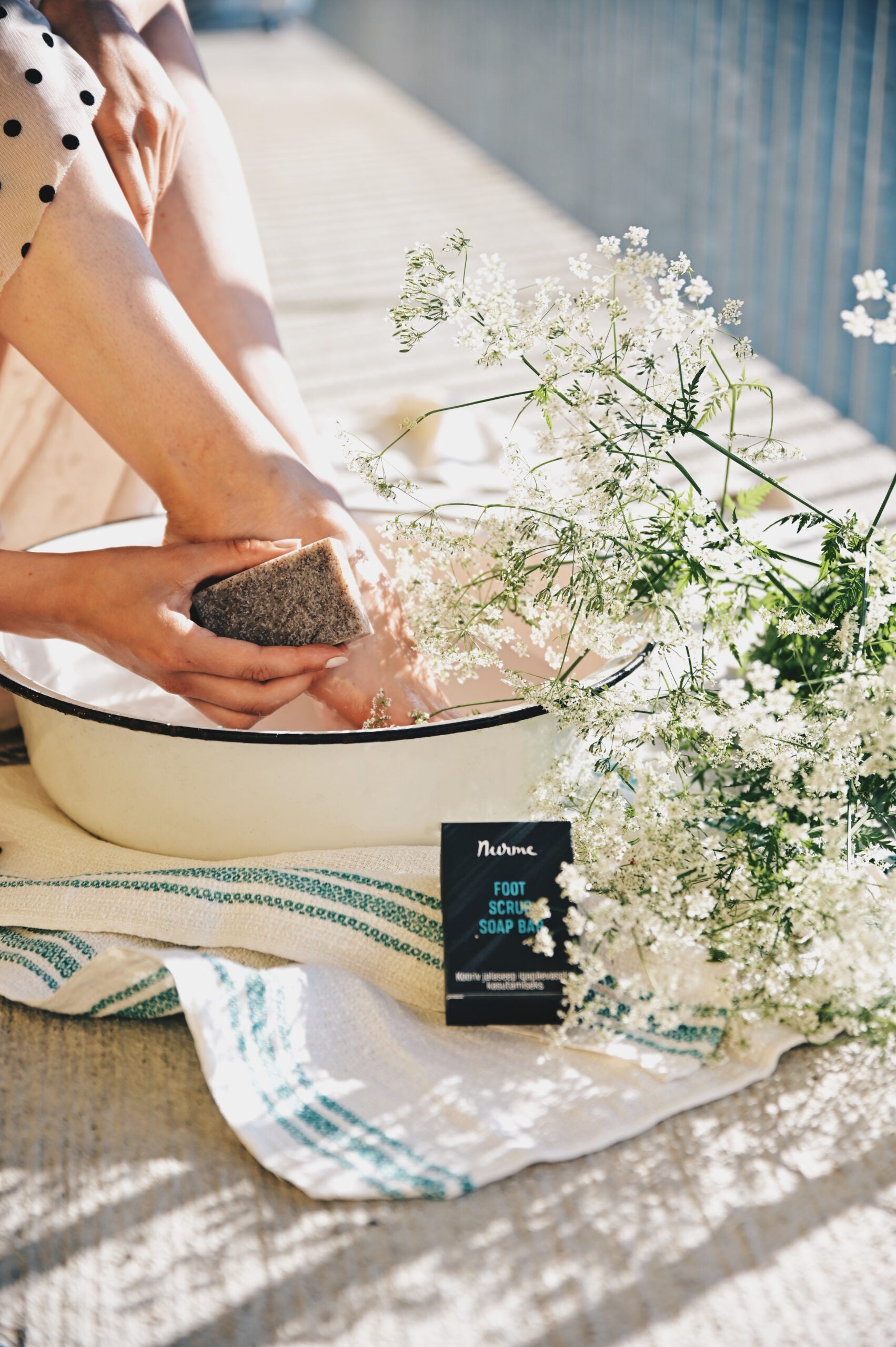 elegant handcrafted foot scrub soap bar with visible pumice and almond shell exfoliants