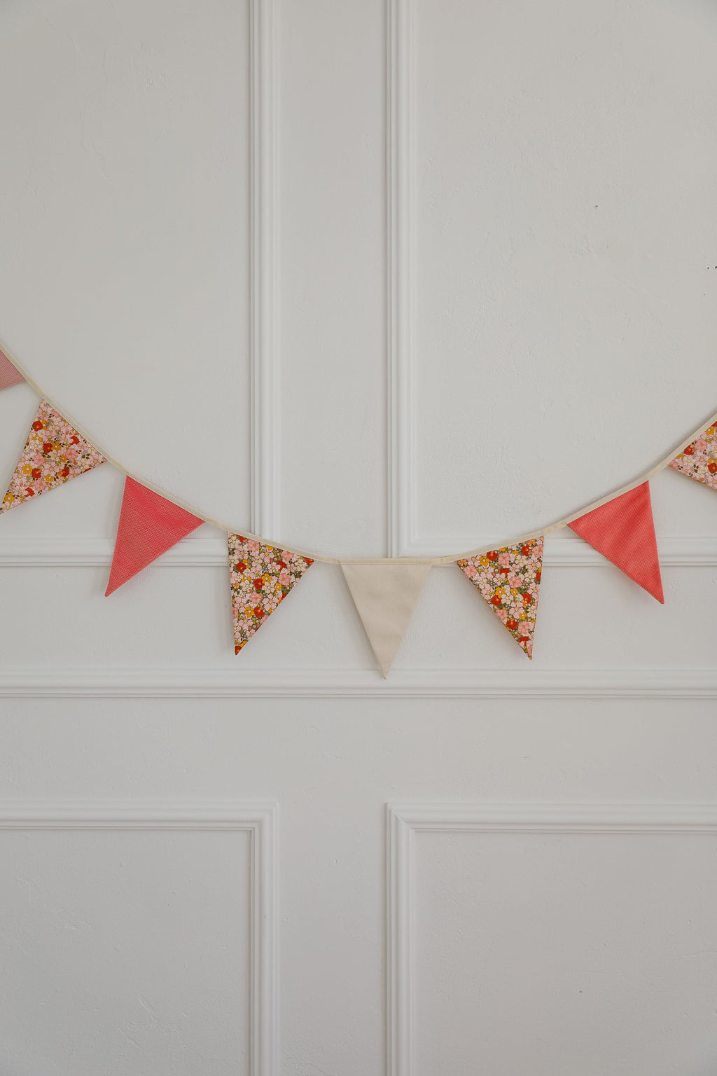 magical cotton and velvet birthday garland draped over a teepee tent for a cozy play nook