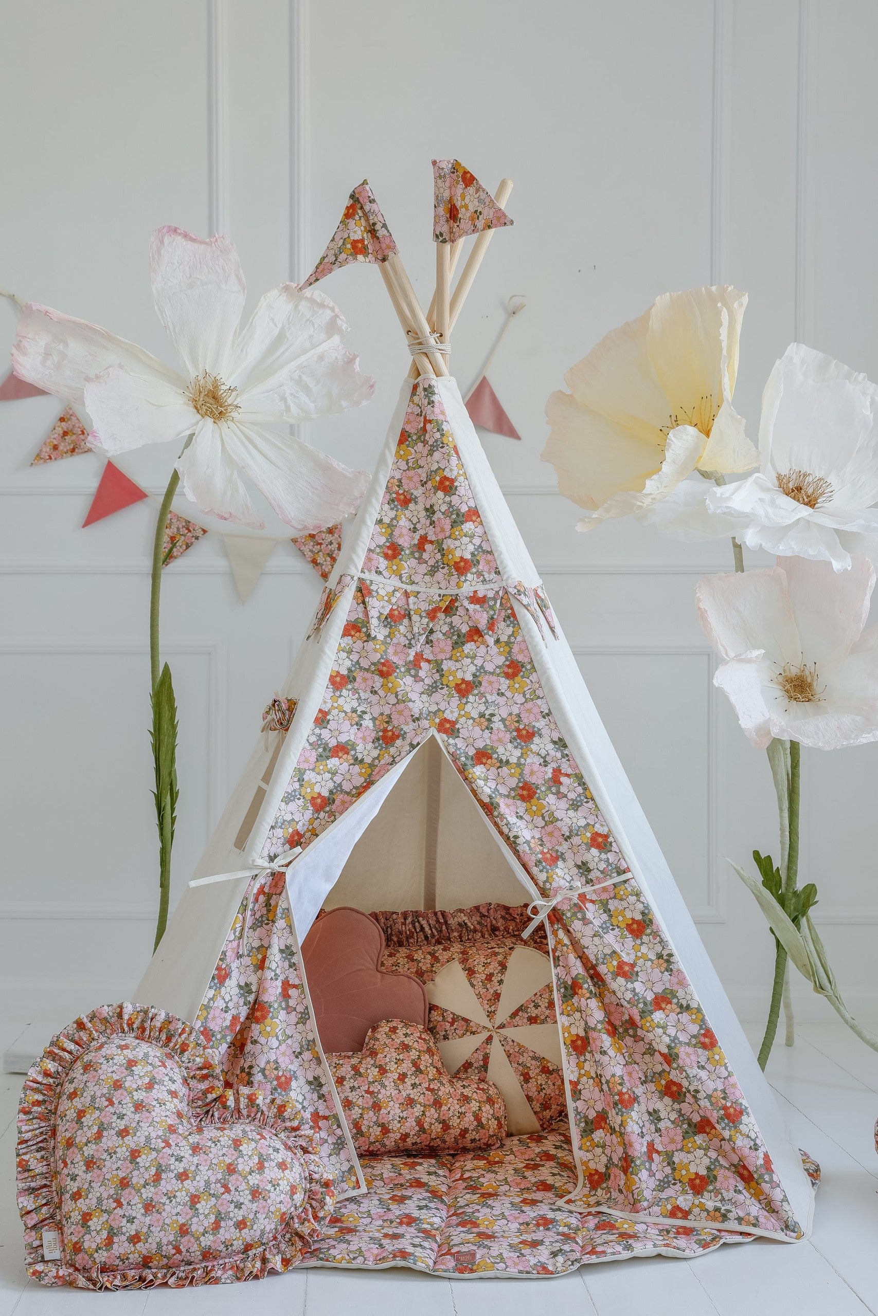 cotton and velvet birthday garland hung over a childs bed for cozy reading nook