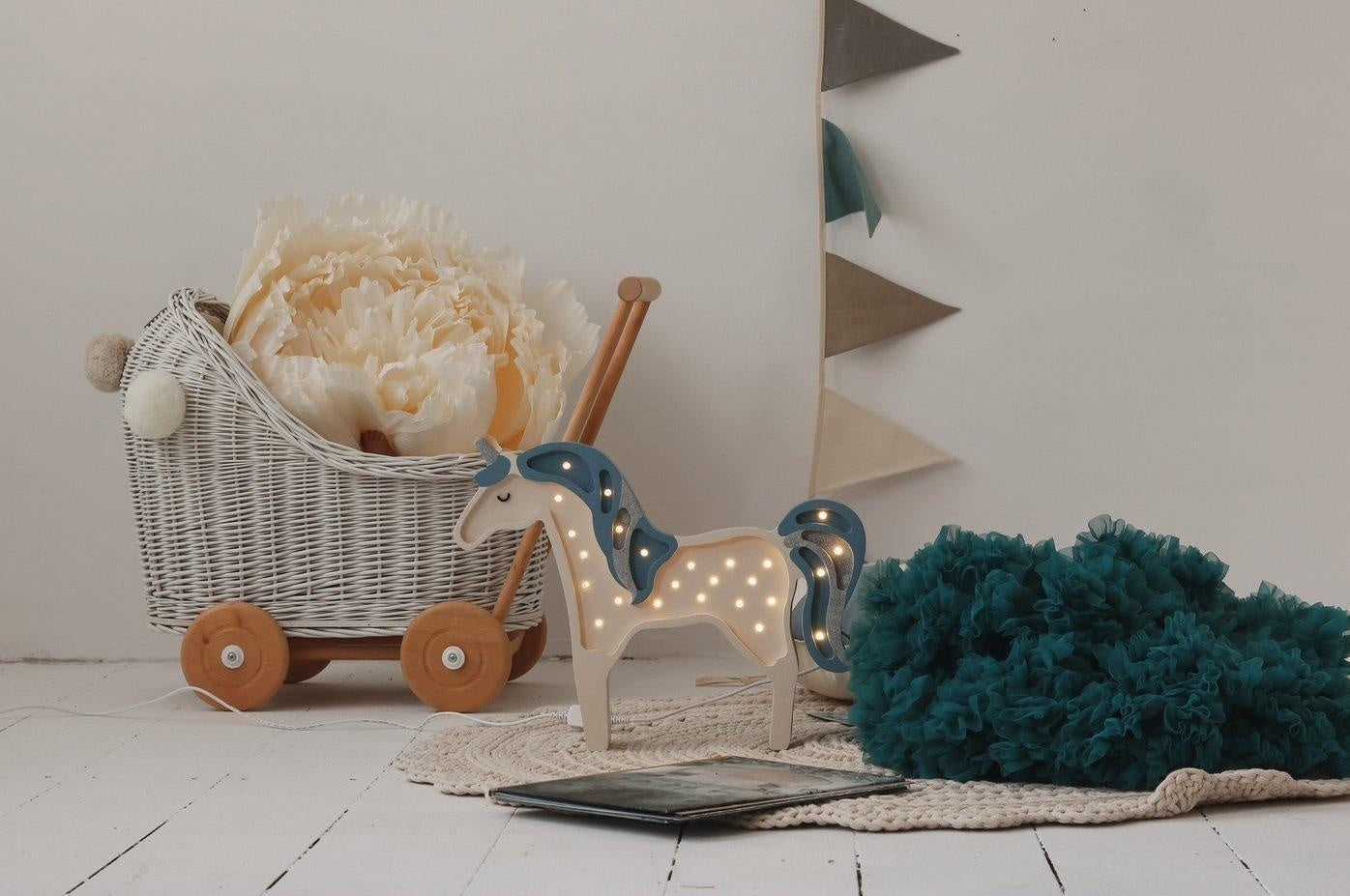 playful teal and grey linen garland draped over a child's play tent