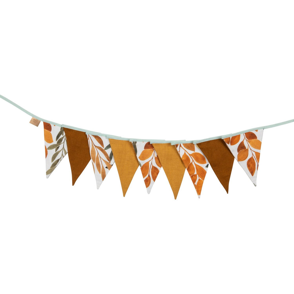 soft cotton and linen forest friends garland gently draped over a cozy reading nook
