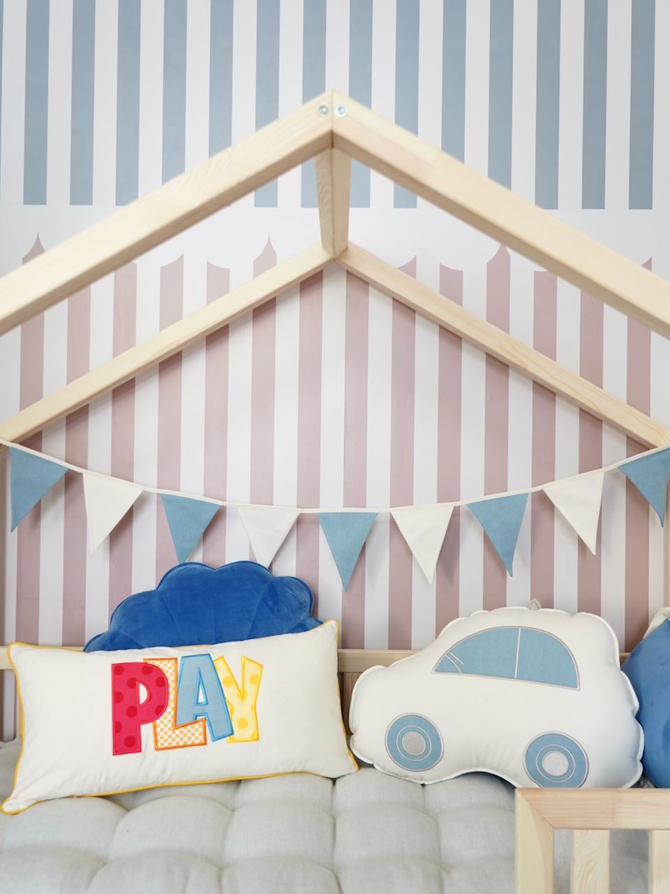 soft cotton and linen jean garland draped over a wooden crib, adding rustic charm to a nursery