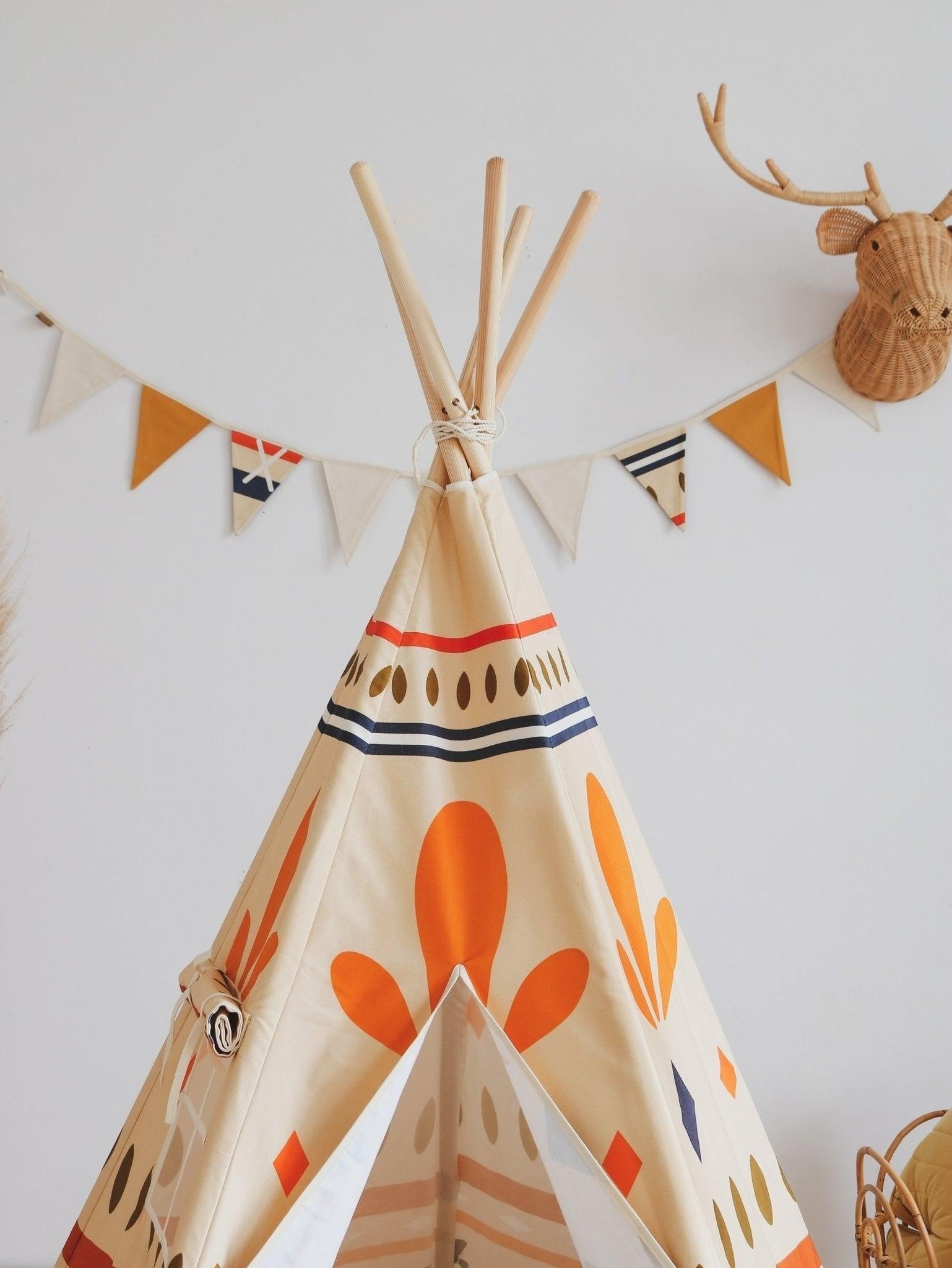 practical 2.2m cotton kids garland hung over a play area with warm geometric shapes