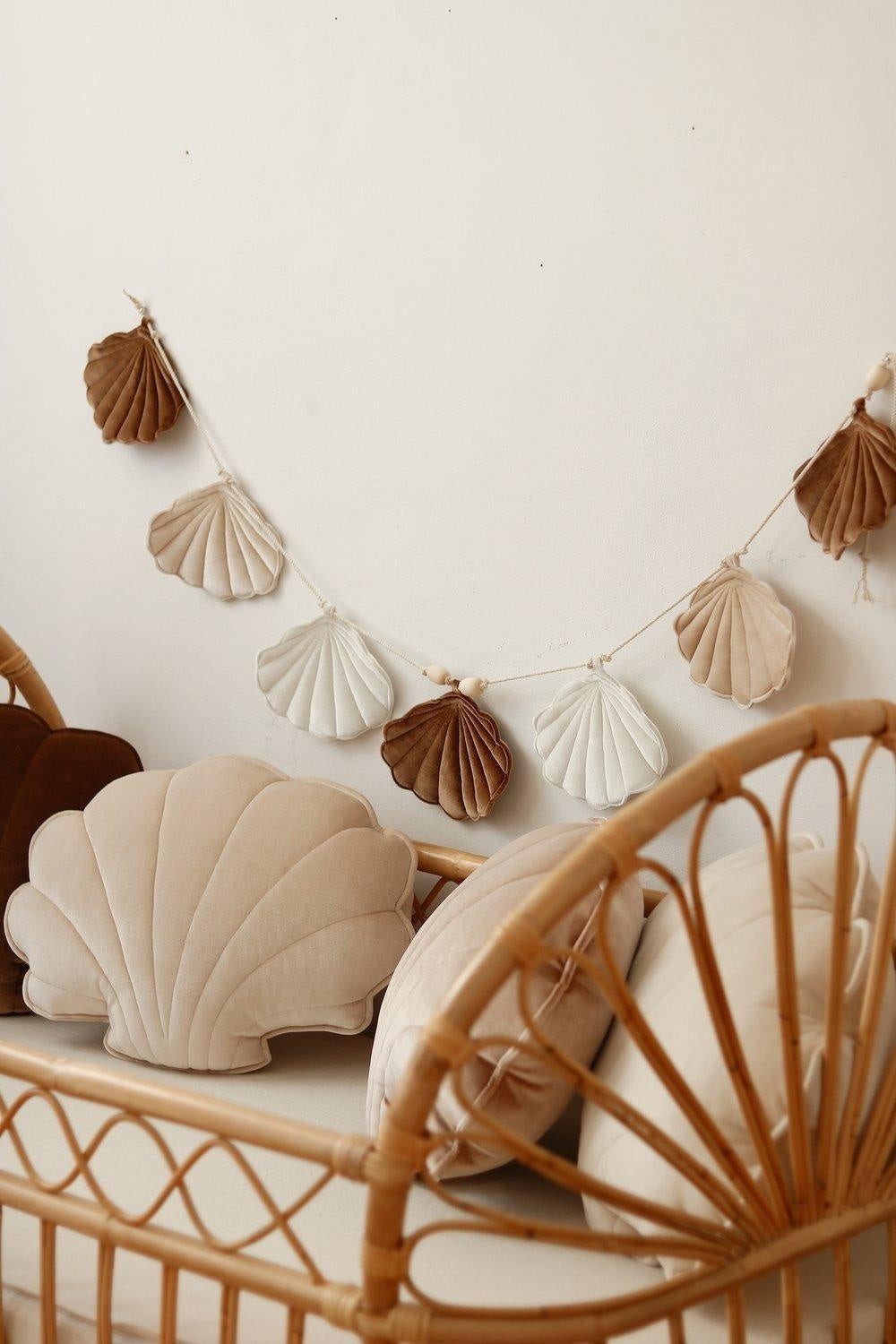 bold beige pearl shell garland with velvet accents, draped elegantly against a sunlit backdrop for royal-inspired decor