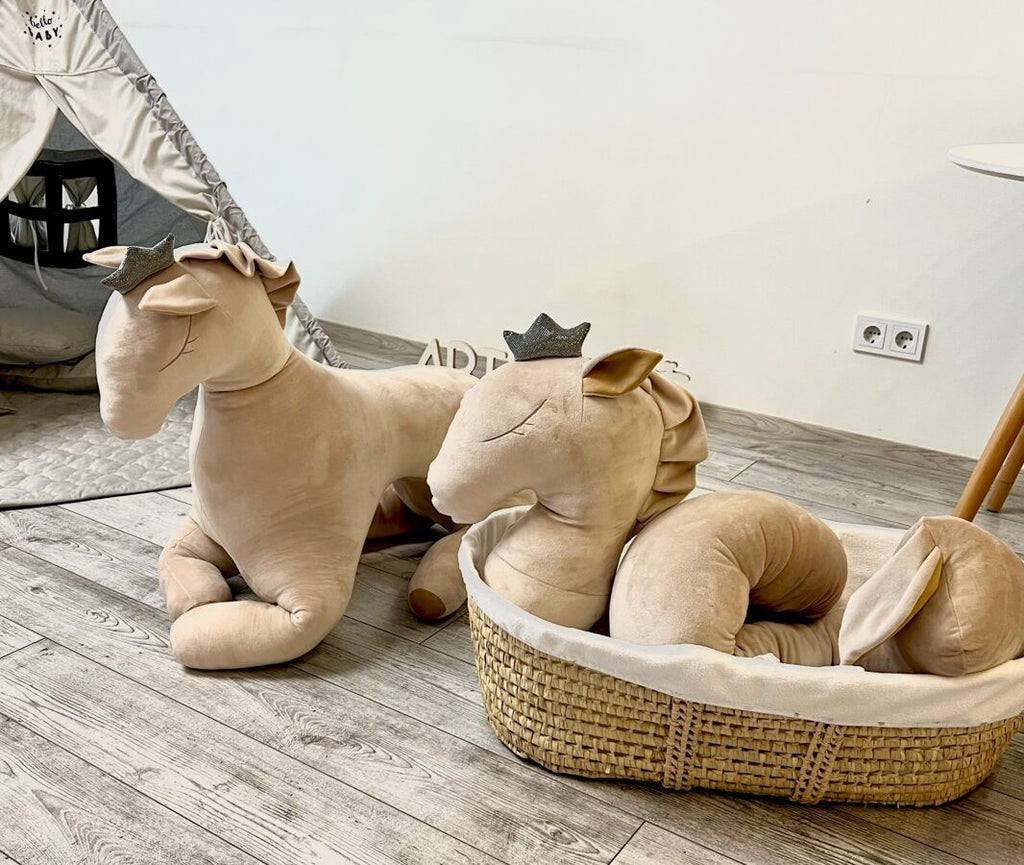 a playful cream velvet pegasus toy with a cheeky grin, ready for nursery adventures