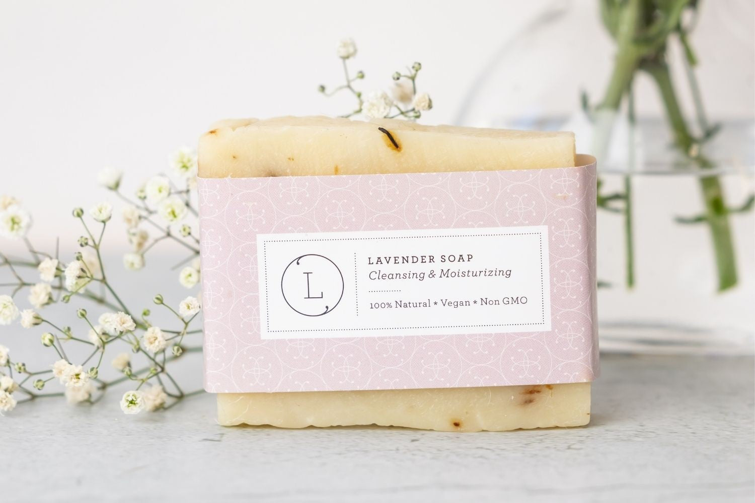 thoughtful organic gift set for moms with lavender soap, journal, and candle arranged practically
