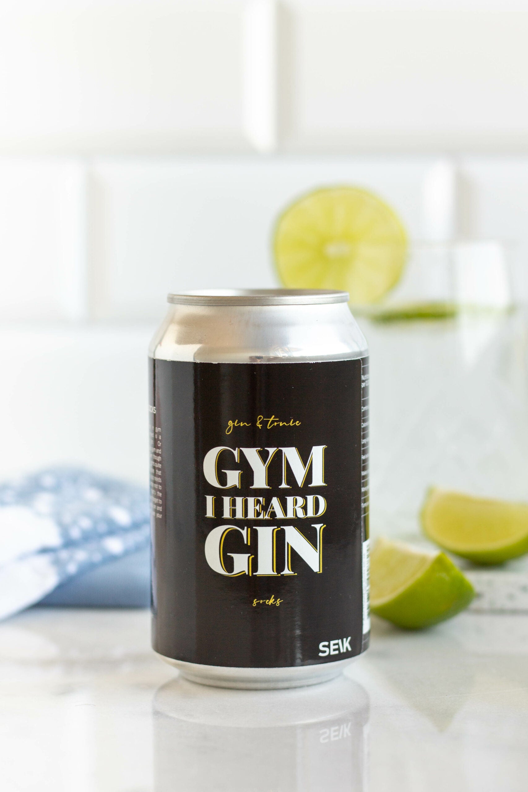 a close-up of gin and tonic socks on a gym floor, celebrating the perfect post-workout reward
