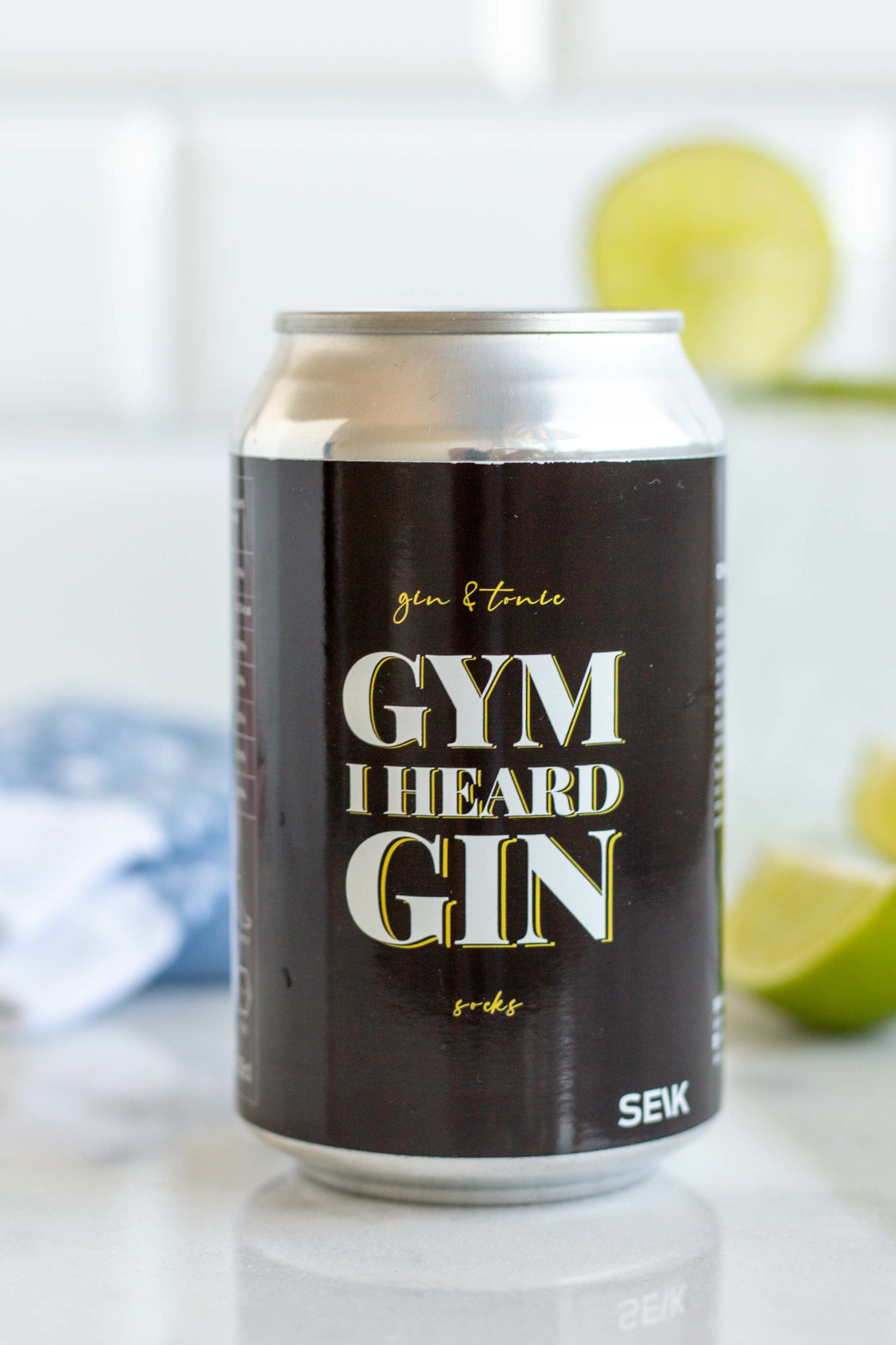 a playful close-up of gin and tonic socks on tiled floor, as if dropped after a fun workout