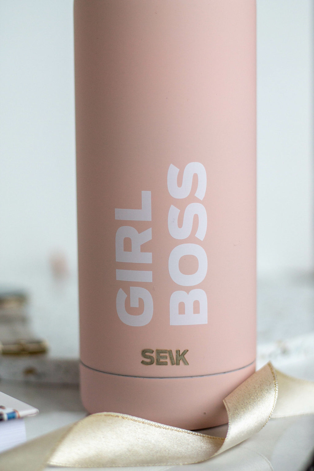 confident girl boss stainless steel water bottle on a modern desk