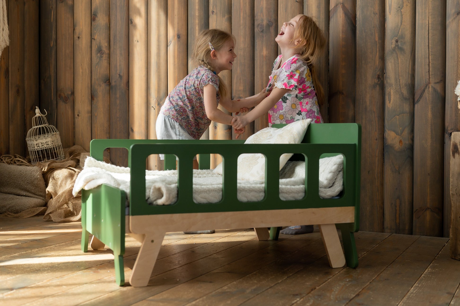 a child's transformative growing bed in a warm, sunlit room, showcasing its space-saving closed sofa form