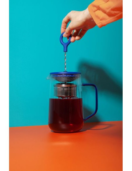 bold blue gyro teapot showcasing its mesmerizing swirling tea infusion in dramatic light