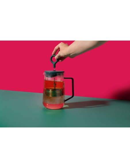 elegant green gyro teapot on a marble countertop with morning light highlighting its refined borosilicate glass form