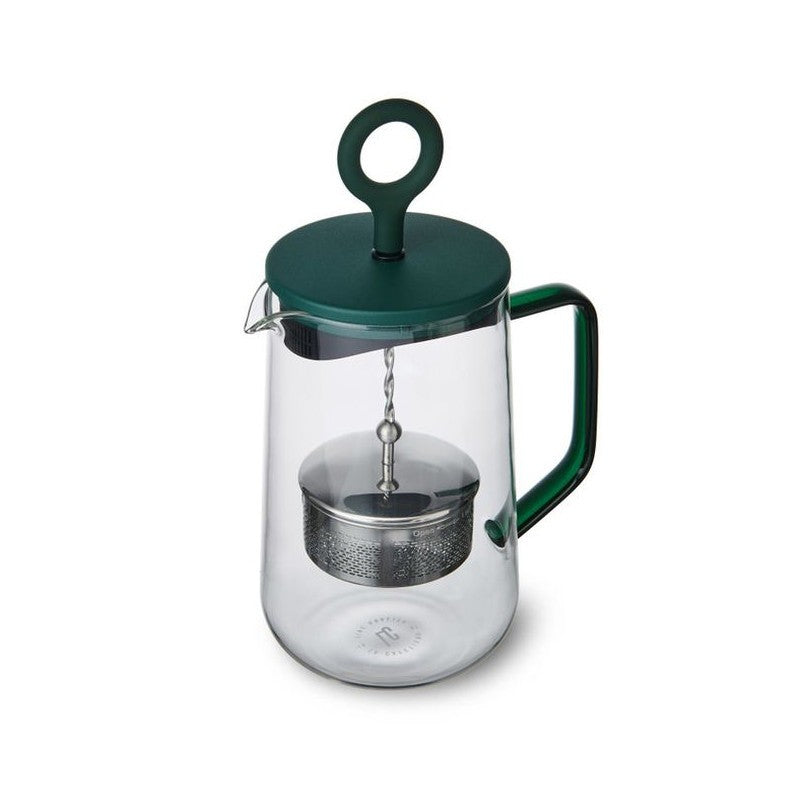 softly lit green gyro teapot on a cozy kitchen table, steam rising gently