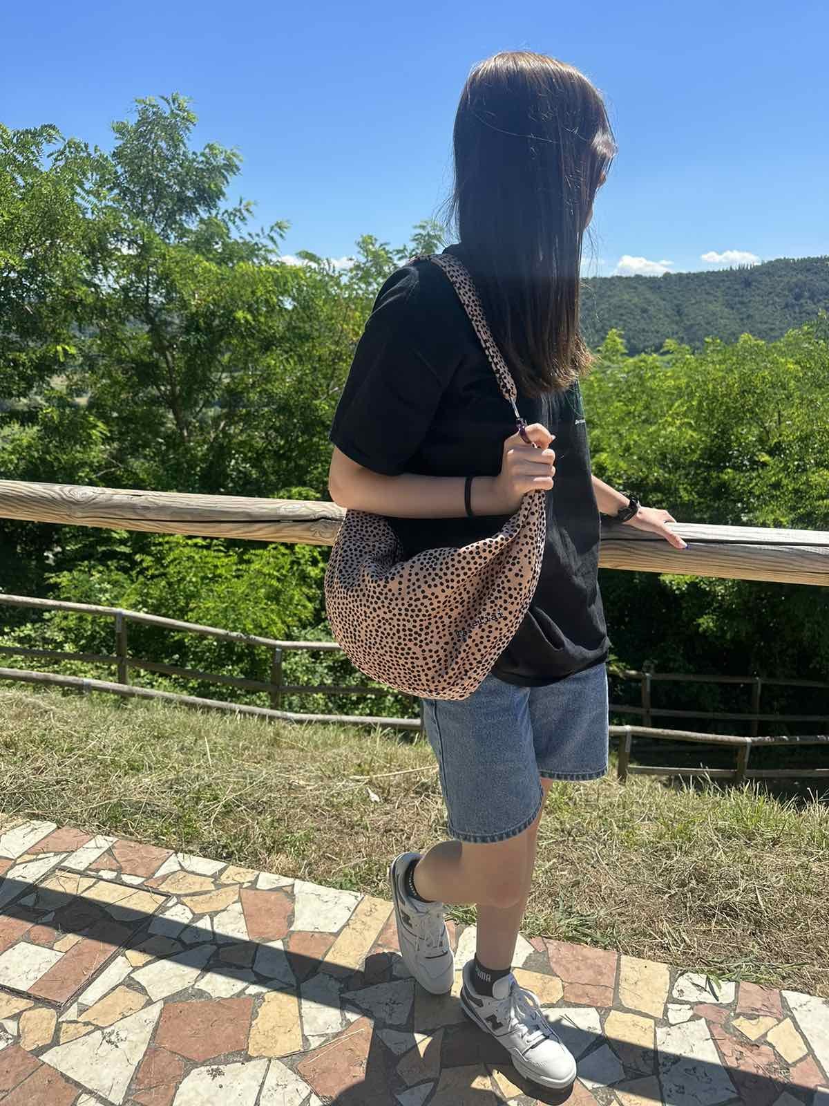 a soft cream velour hobo bag with playful polka dots, shown in a comforting morning light