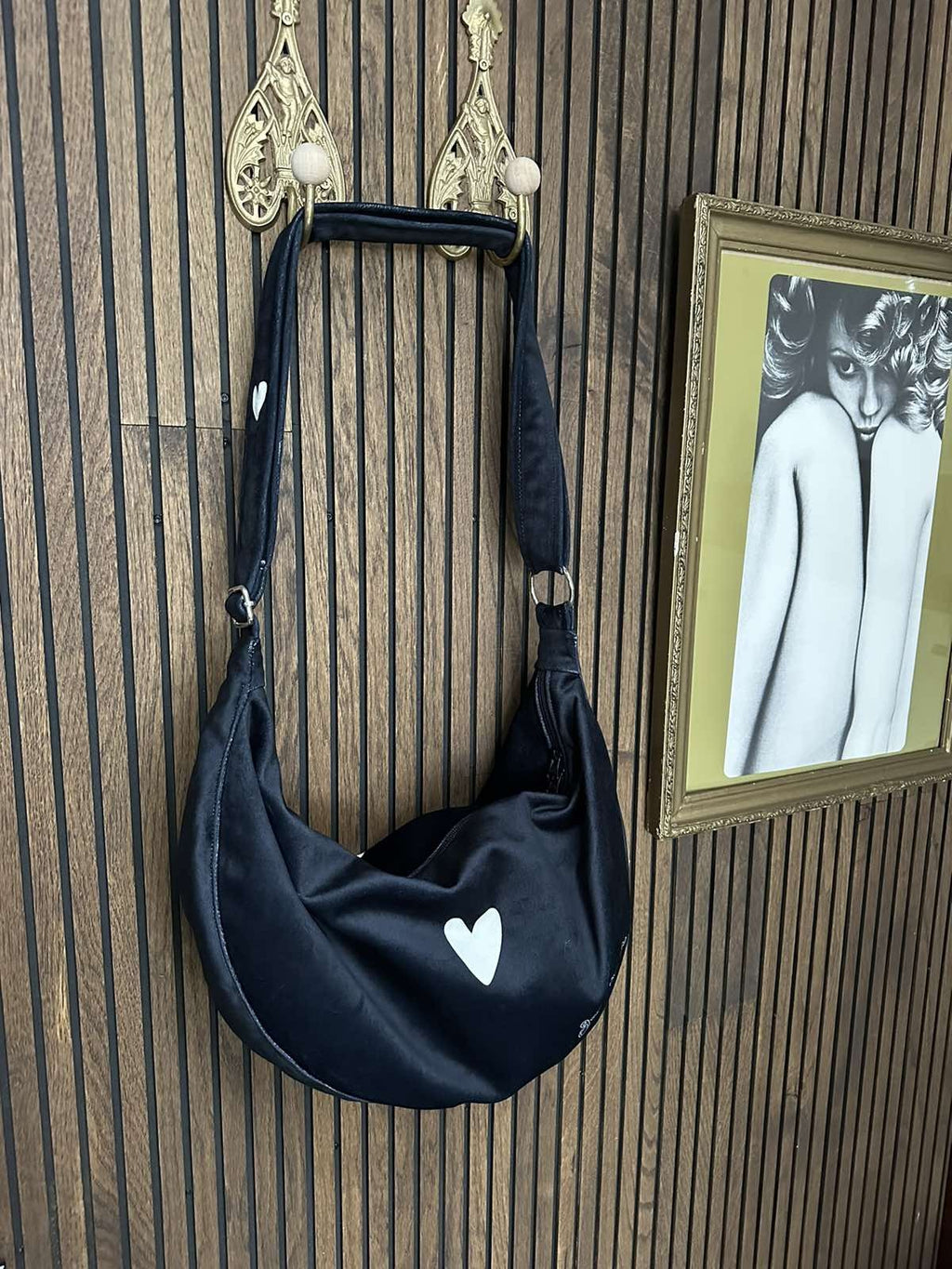 close-up of the chic black hobo bag's adjustable strap and interior pockets