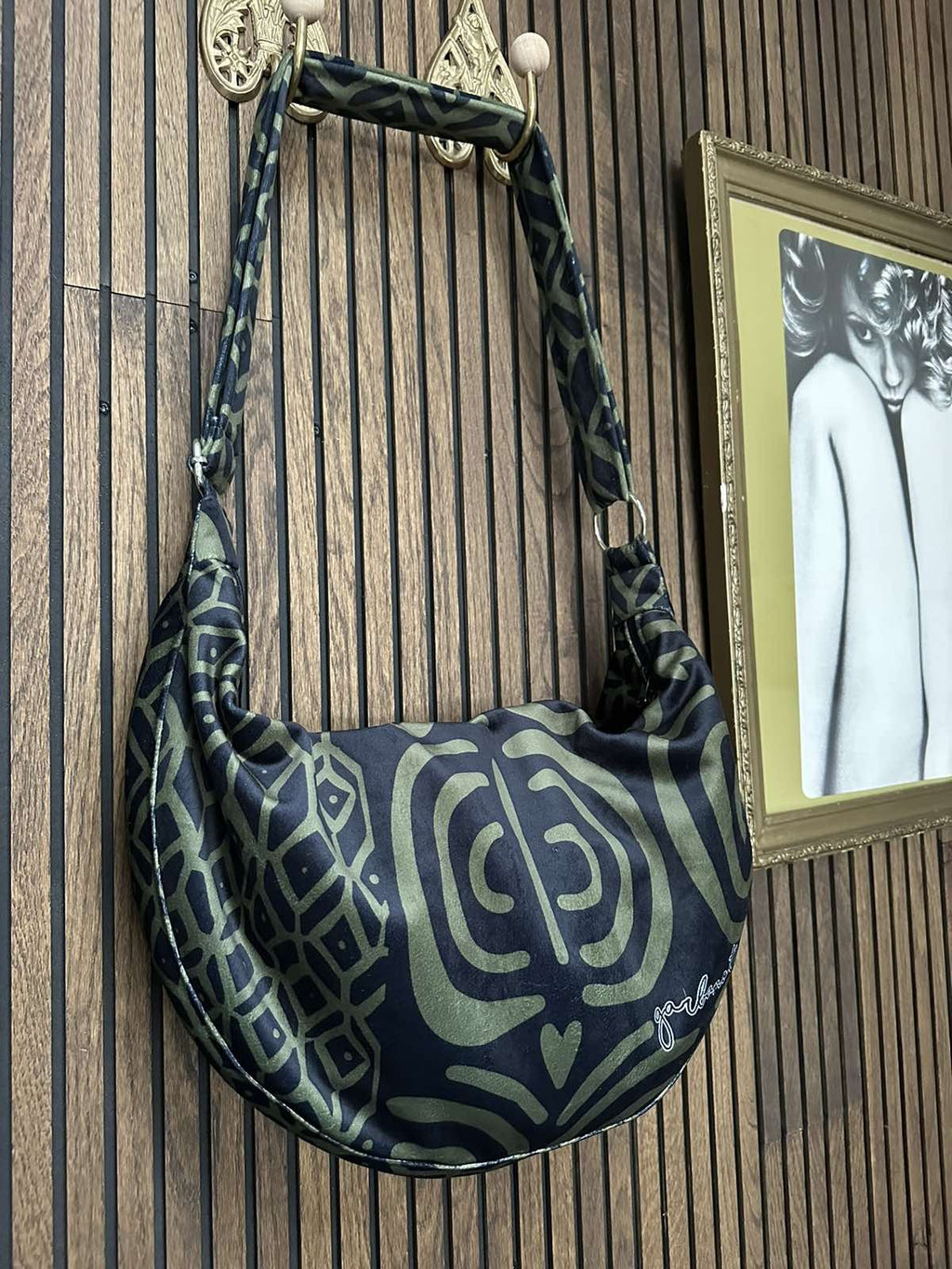 elegant khaki velour hobo bag with an adjustable strap, shown in soft natural light