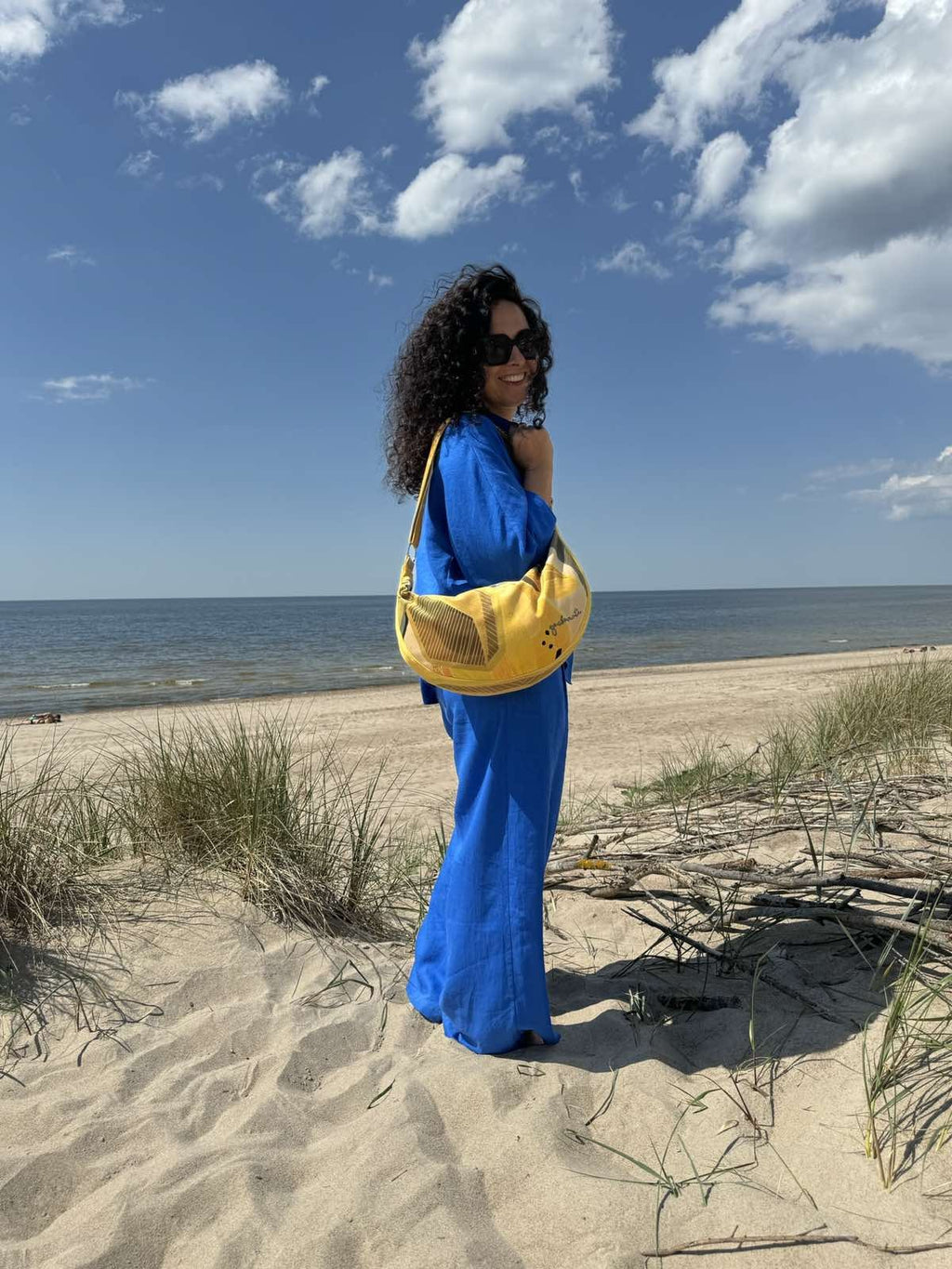 soft velour lemon hobo bag in warm morning light, showing its comfortable slouch and adjustable strap