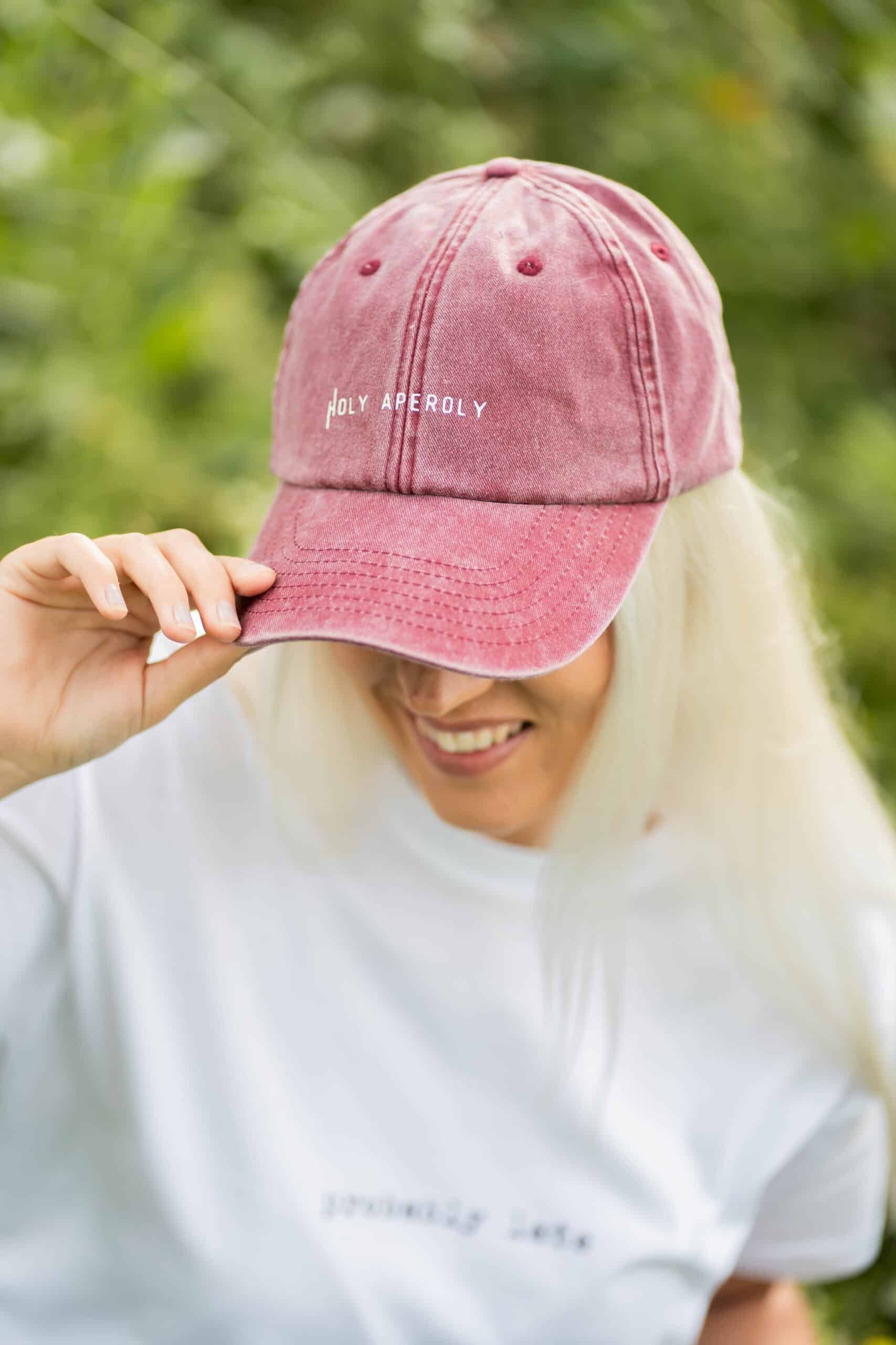 elegant pastel cotton cap with a brass buckle, shown in soft, refined lighting on a minimalist background