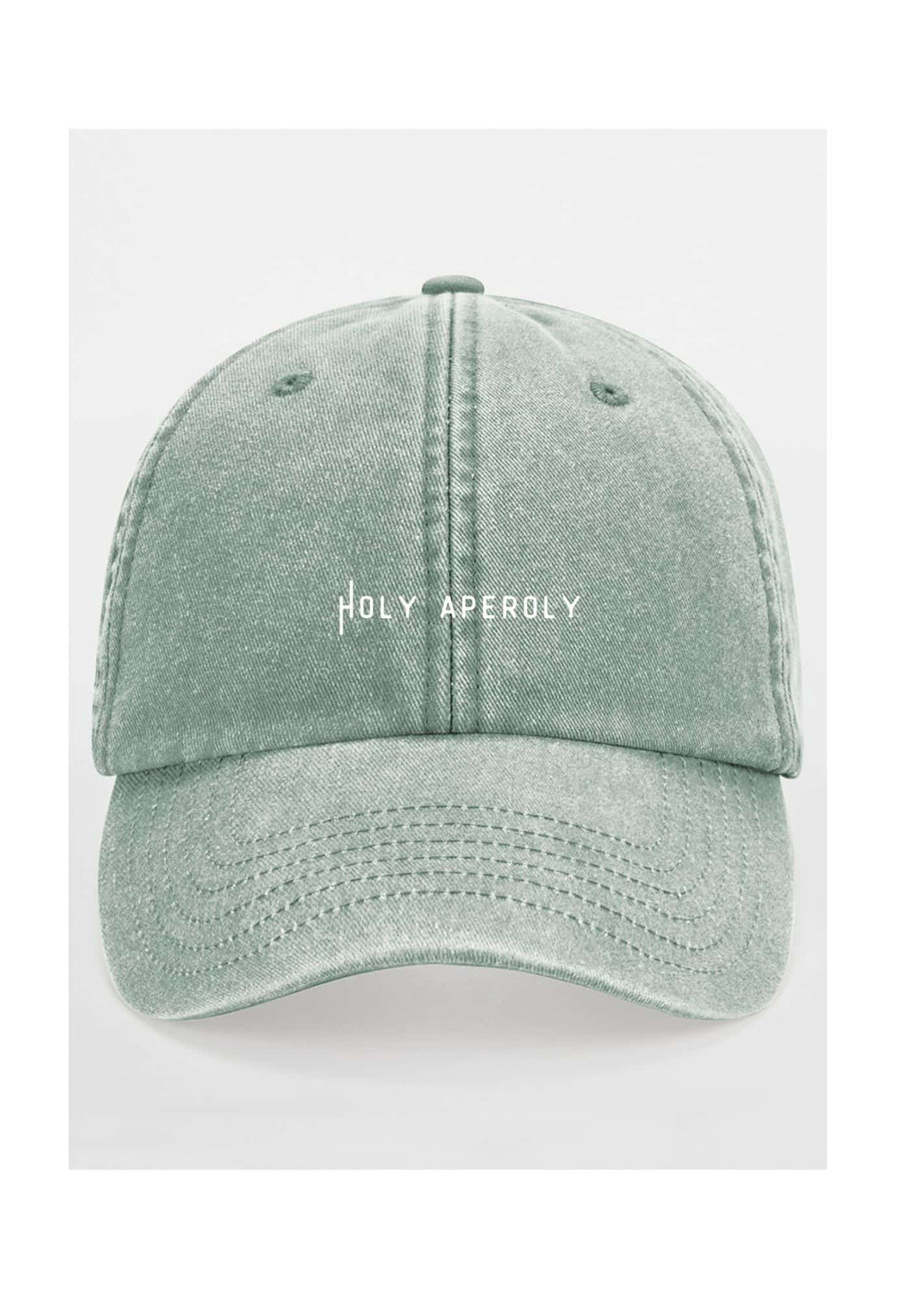 a playful close-up of the pastel cotton cap's soft, faded fabric and brass buckle