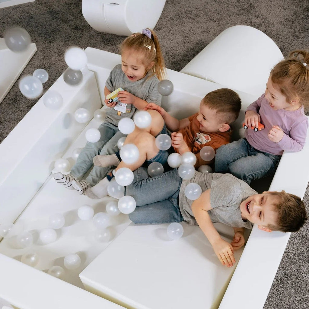 a soft, comforting pile of 500 white ball pit balls for a baby's sensory play