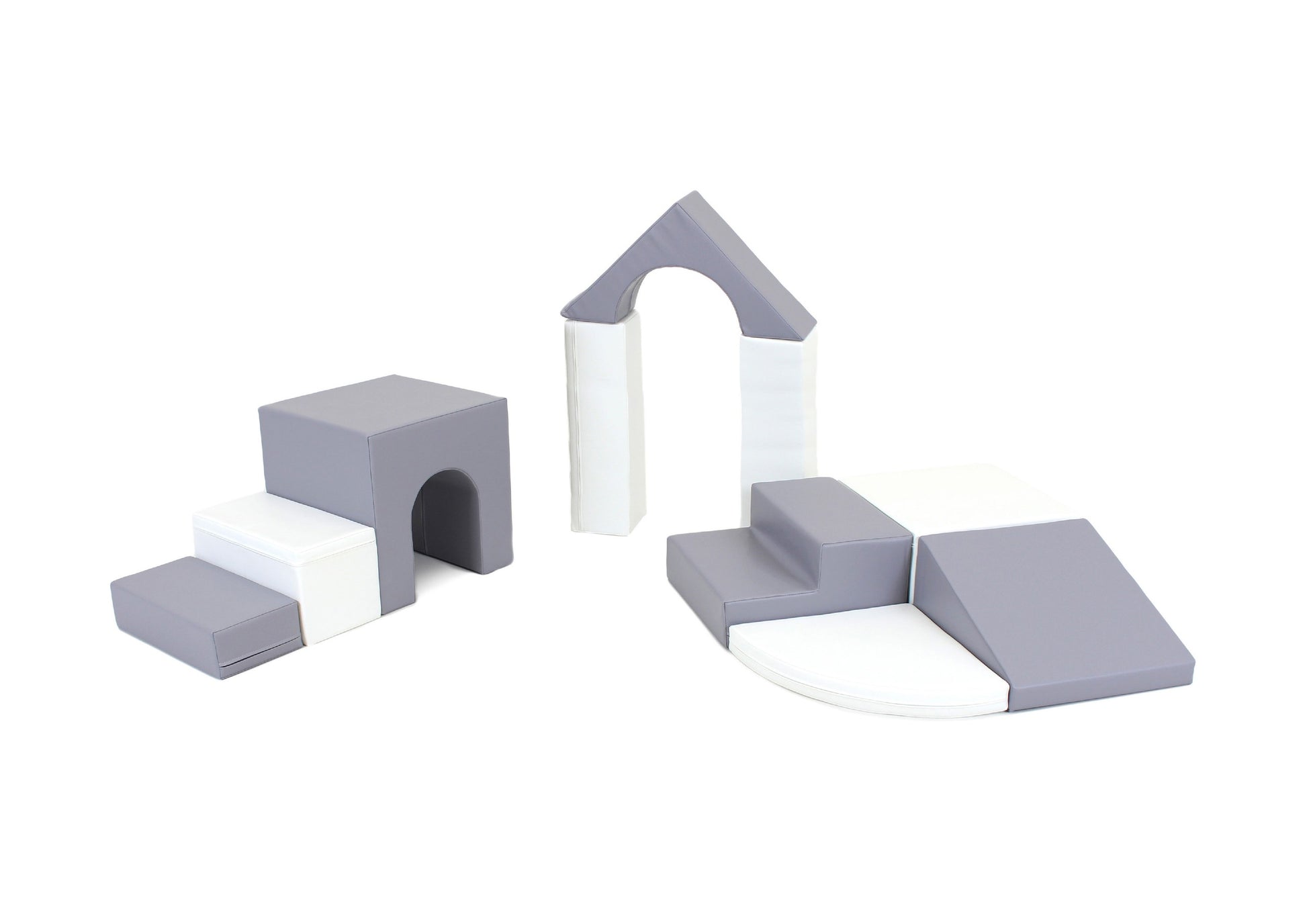 a child's small hands building a tall tower with grey and white iglu foam blocks