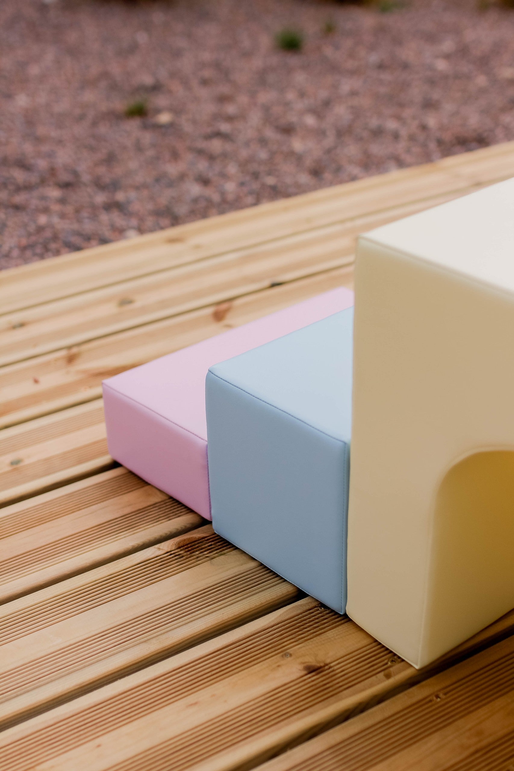 a child building a creative pastel igloo with soft light-pink foam blocks