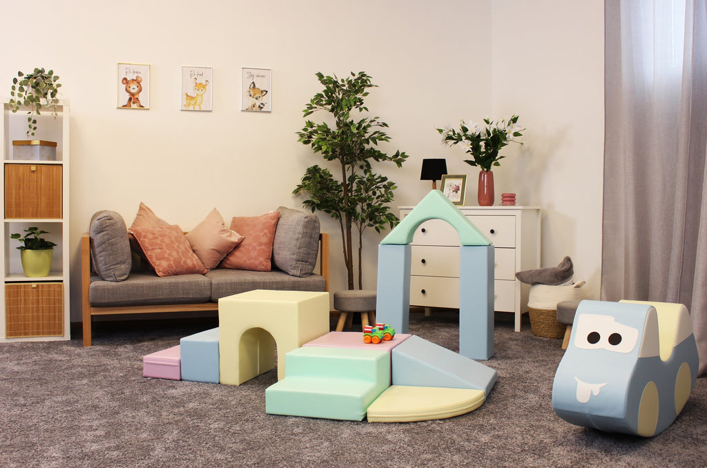 confident toddler building a tall pastel igloo with soft foam blocks