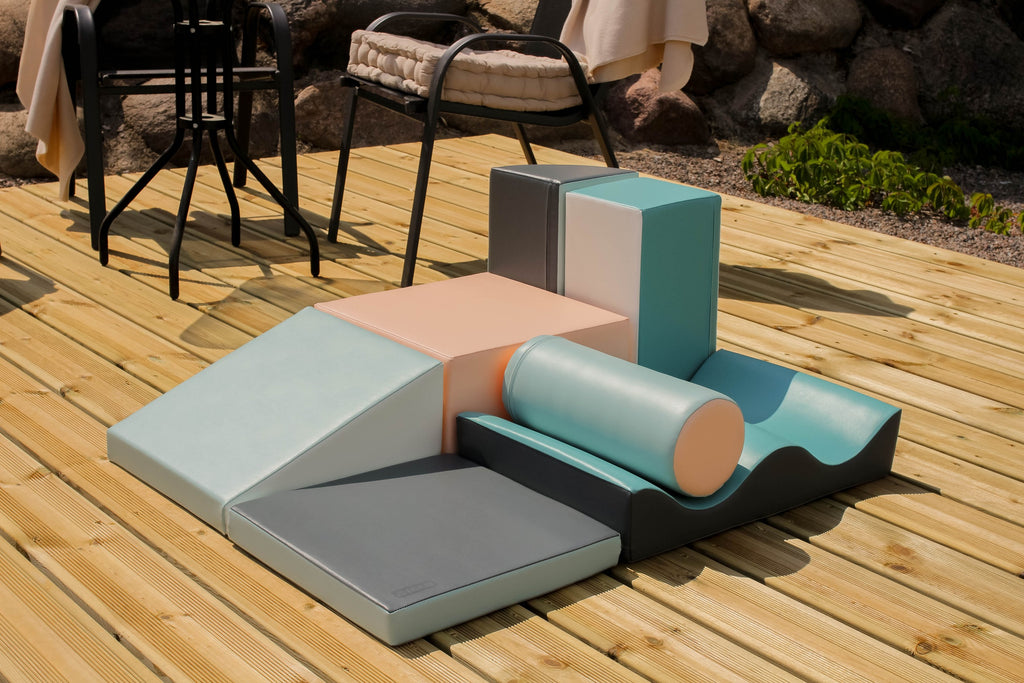 iglu discoverer soft play blocks arranged in a sturdy tower by a child in a sunlit playroom