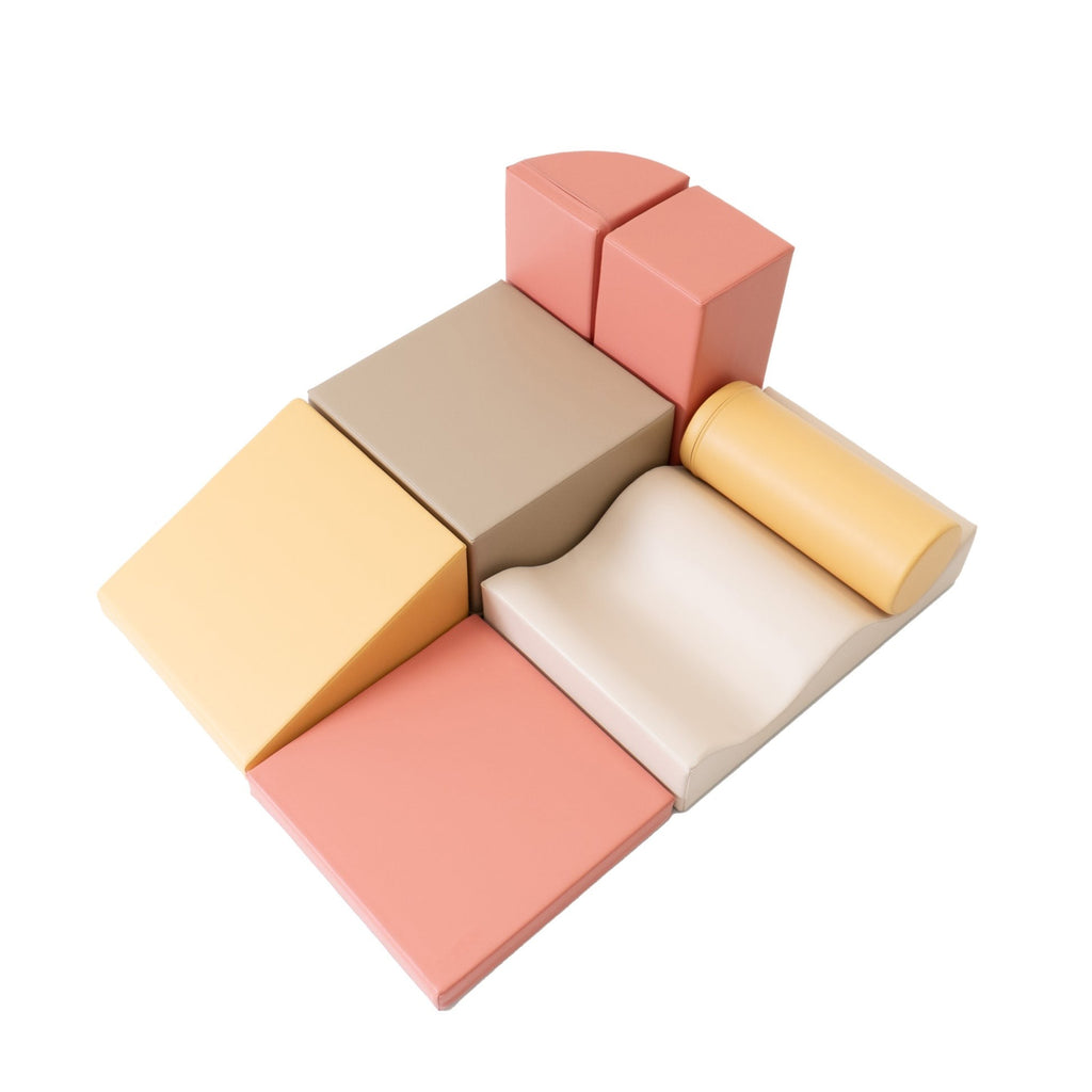 smiling toddler building a pastel pink iglu foam block tower in a sunlit playroom