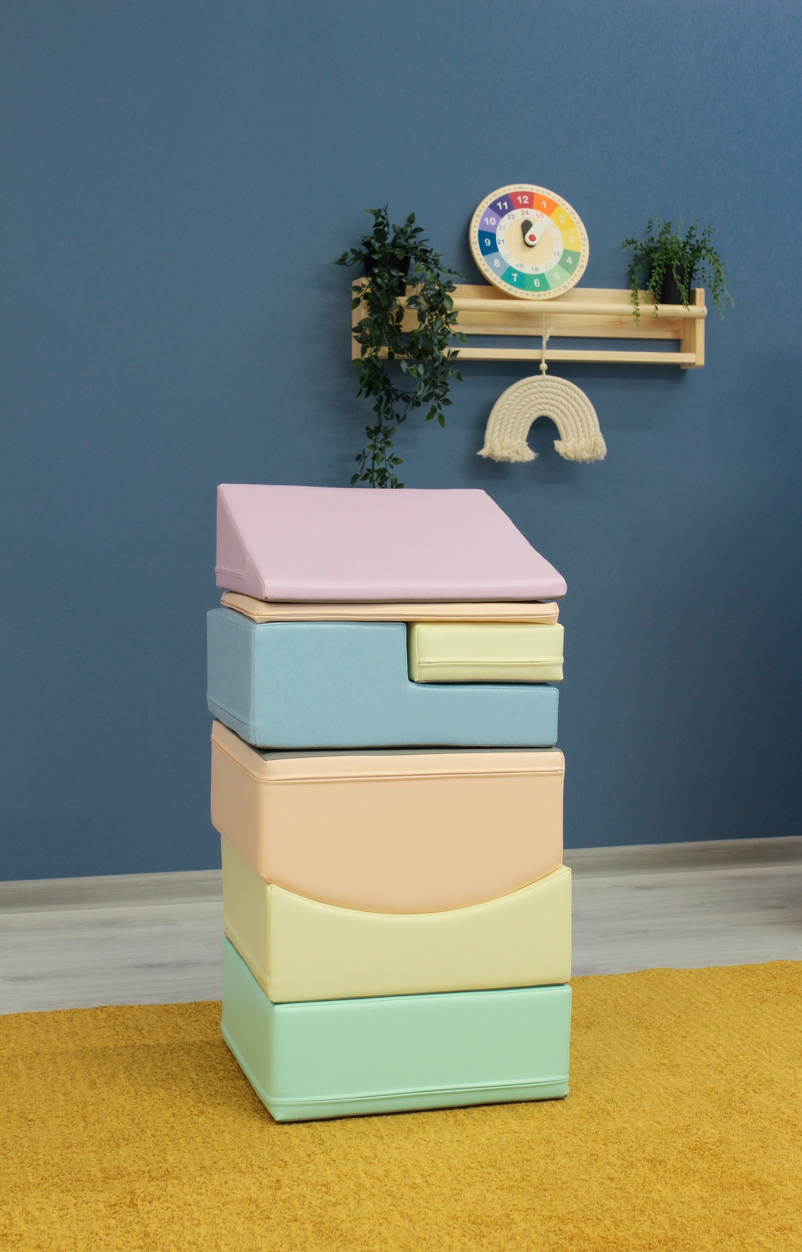 a toddler laughing while stacking soft pastel foam blocks in a sunlit playroom