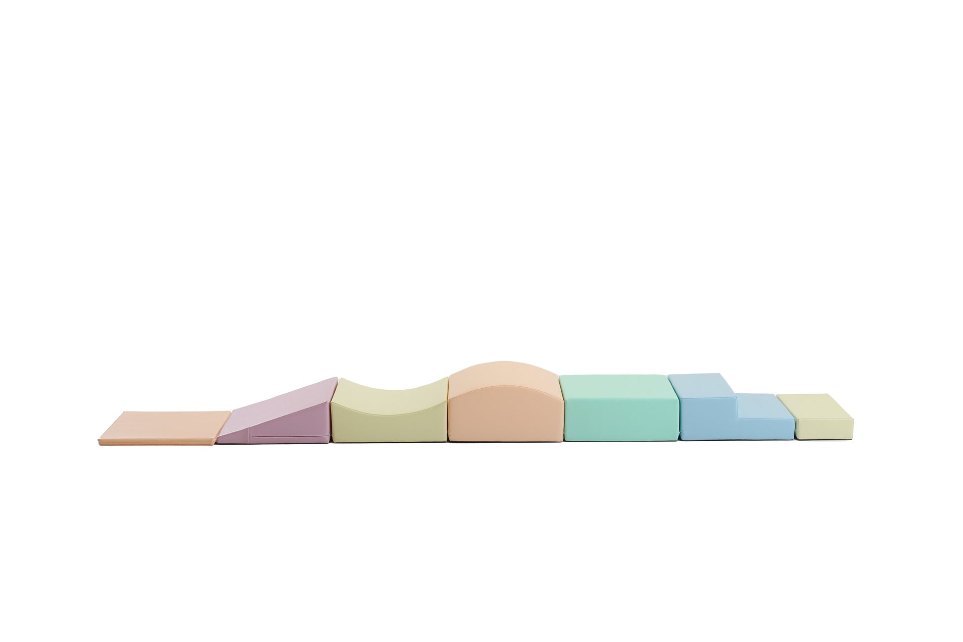 a toddler building a soft pastel igloo with eco-leather foam blocks