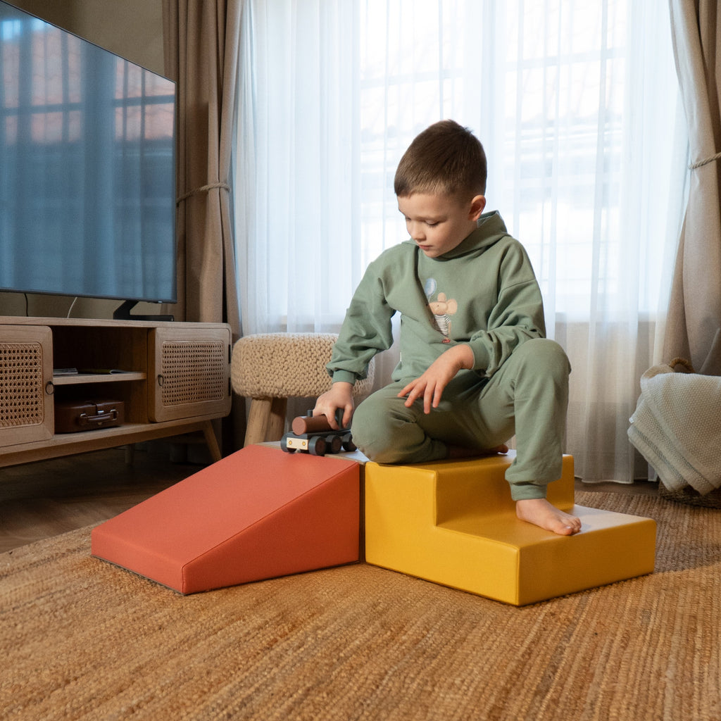 a soft pink foam climbing block set arranged in a gentle, inviting nest for a toddler's quiet play