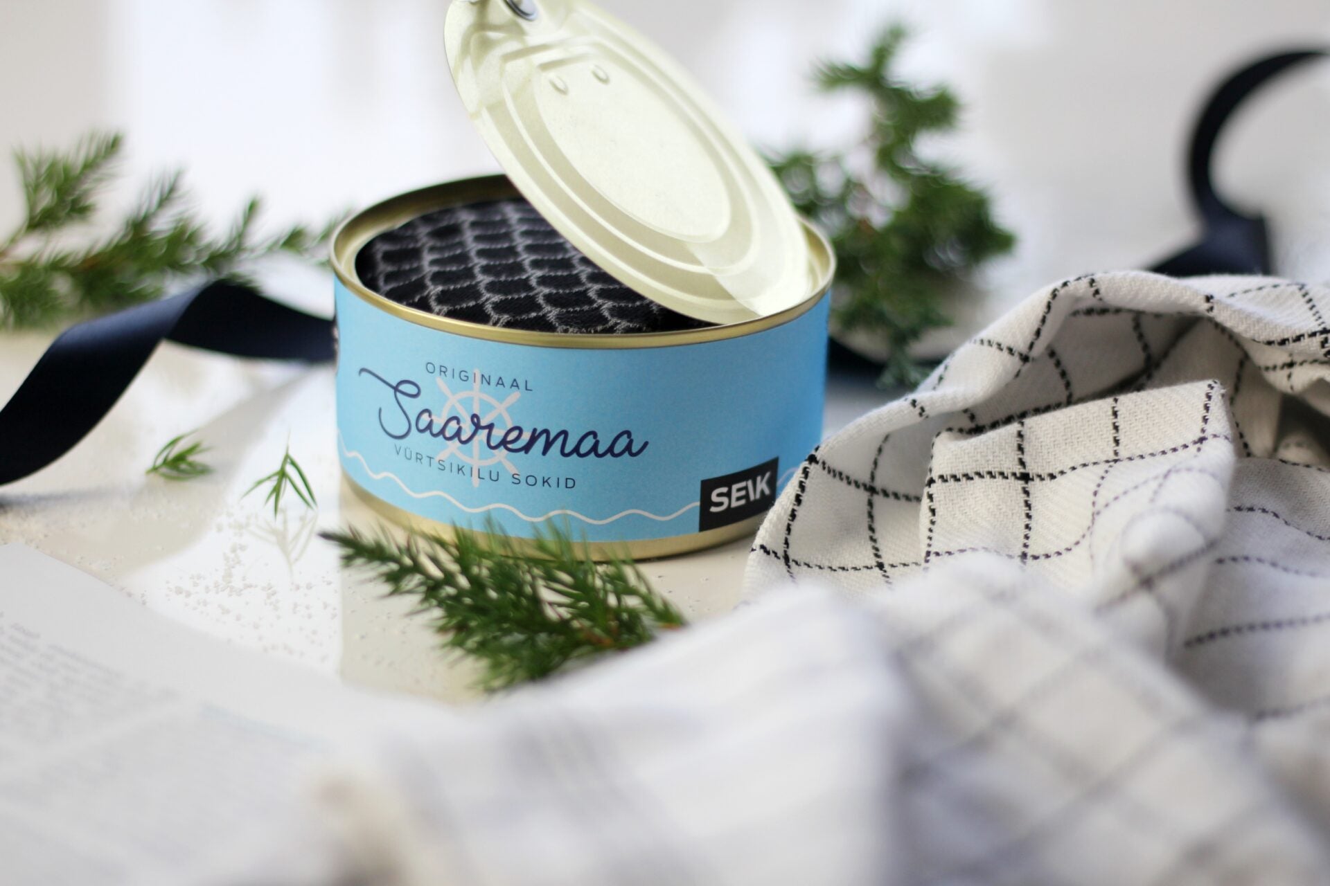 a close-up detail of the soft herring-patterned cotton sock cuff on a wooden dock
