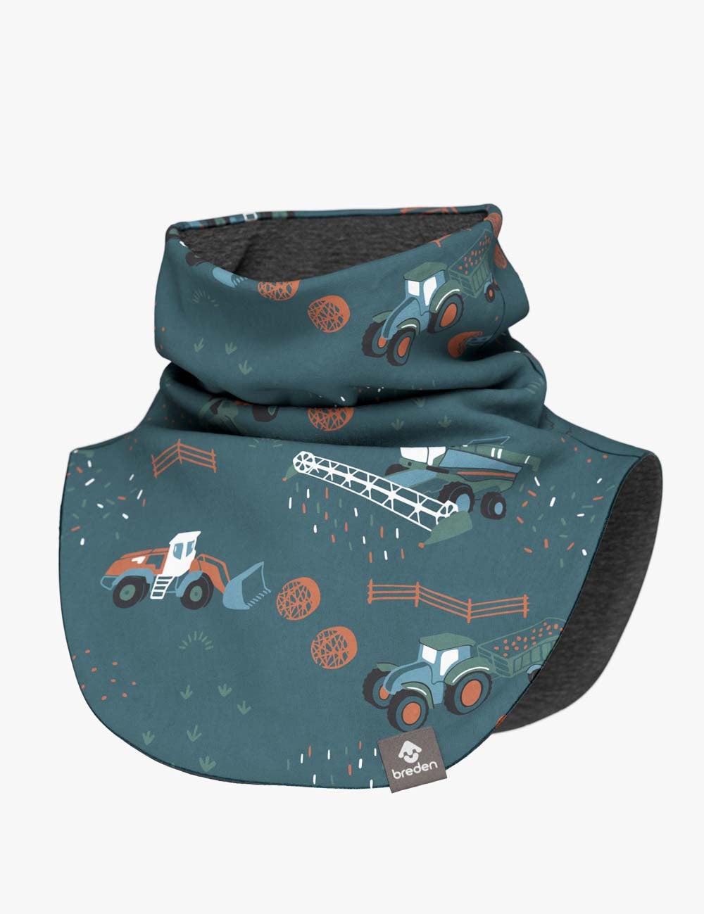 bold close-up of a kids tractor-print neck warmer on a rustic wooden fence