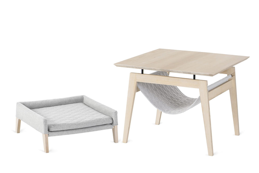 a serene anthracite ash wood pet bed and table set in soft morning light