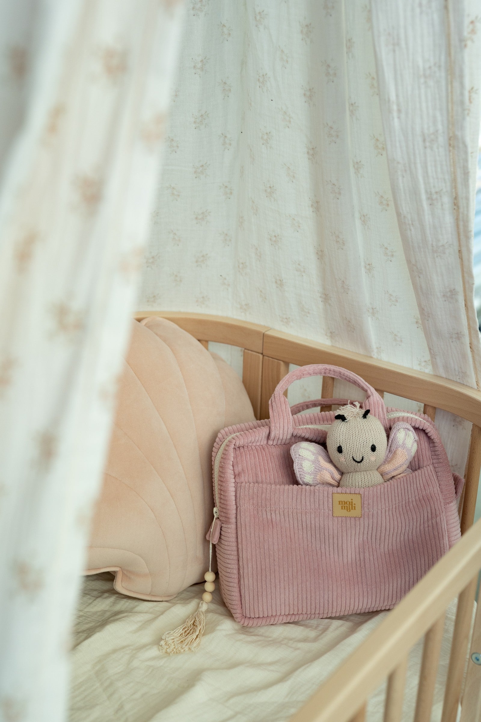 baby pink cotton makeup bag open on a table showing its waterproof lining and interior pocket