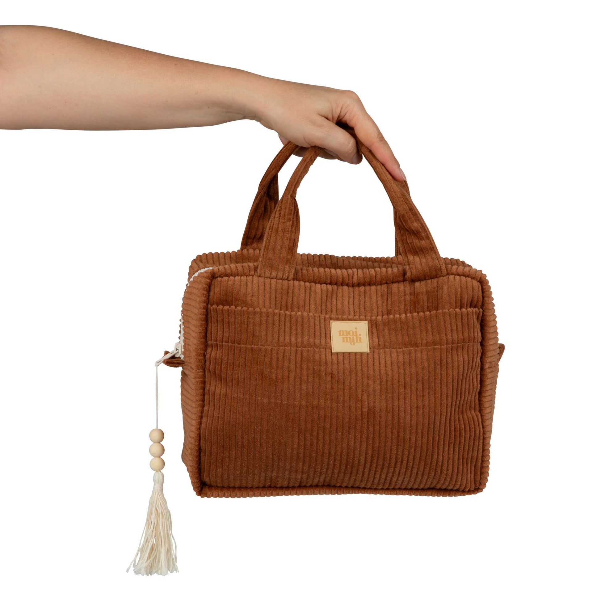 bold caramel makeup bag set of two lying open on a dark surface