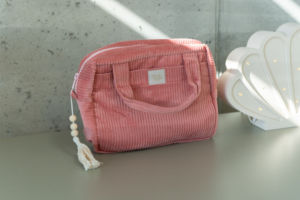 soft coral cotton makeup bag set with two sizes open on a cozy surface