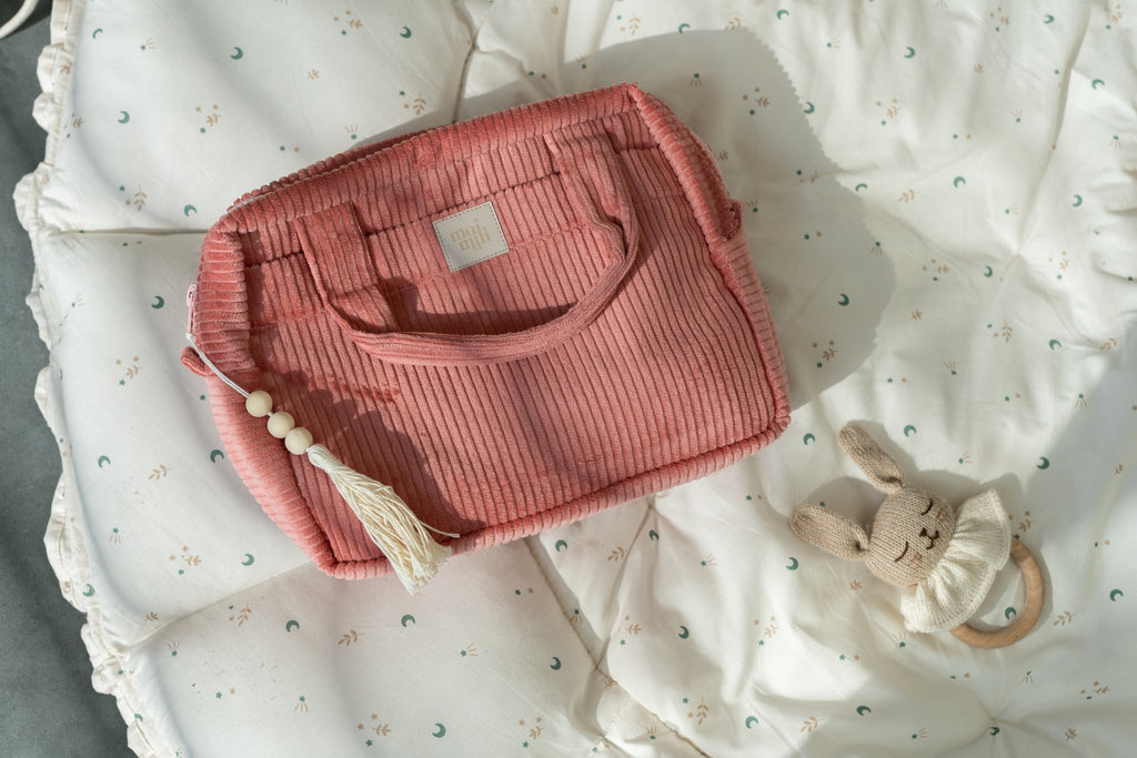 functional coral cotton makeup bag set open on a table showing its waterproof interior and pockets