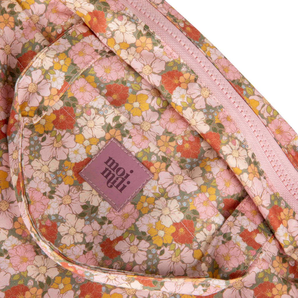 functional green garden makeup bag set open on a table showing interior pockets and waterproof lining