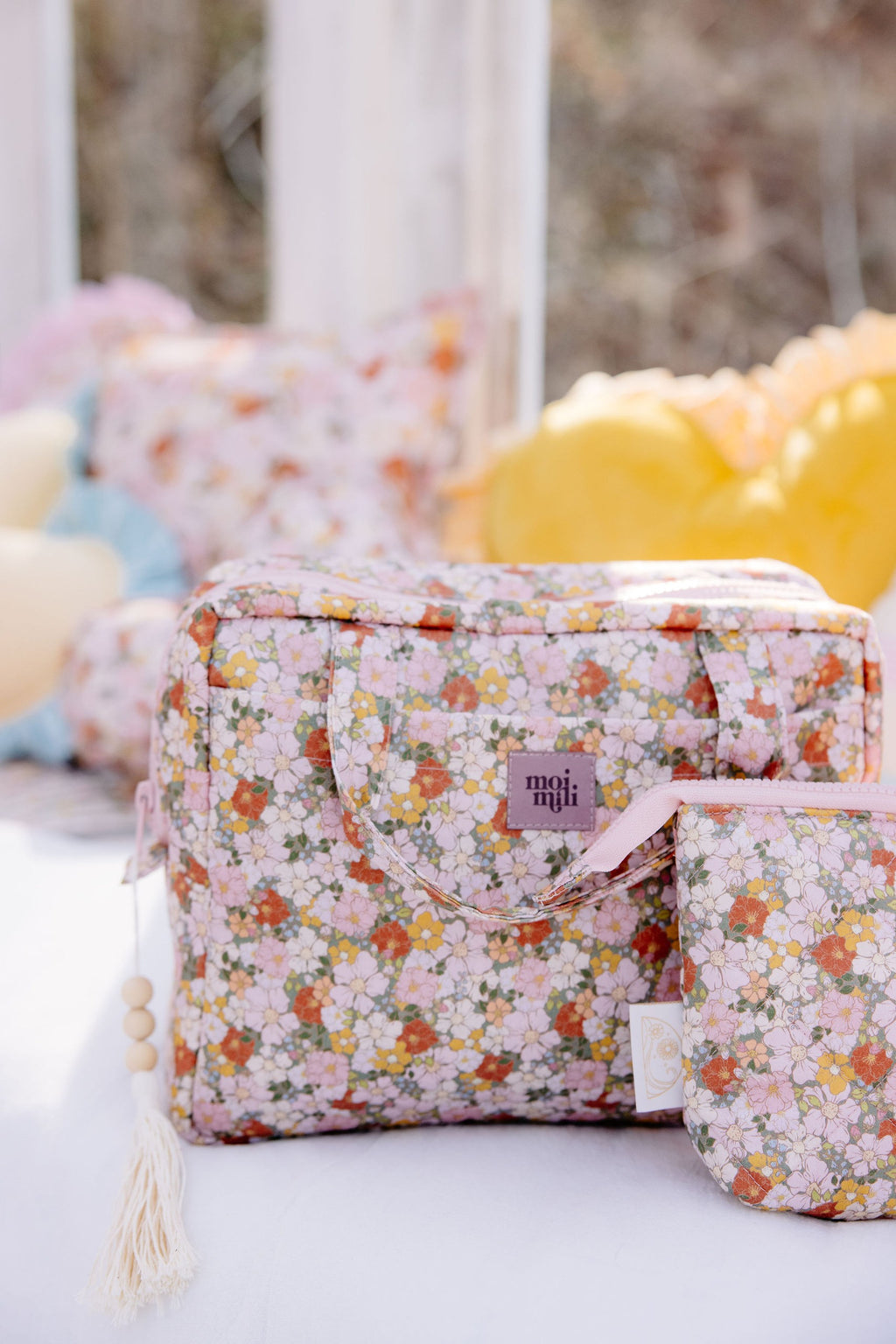handmade green garden makeup bag set of two lying open on a rustic wooden table