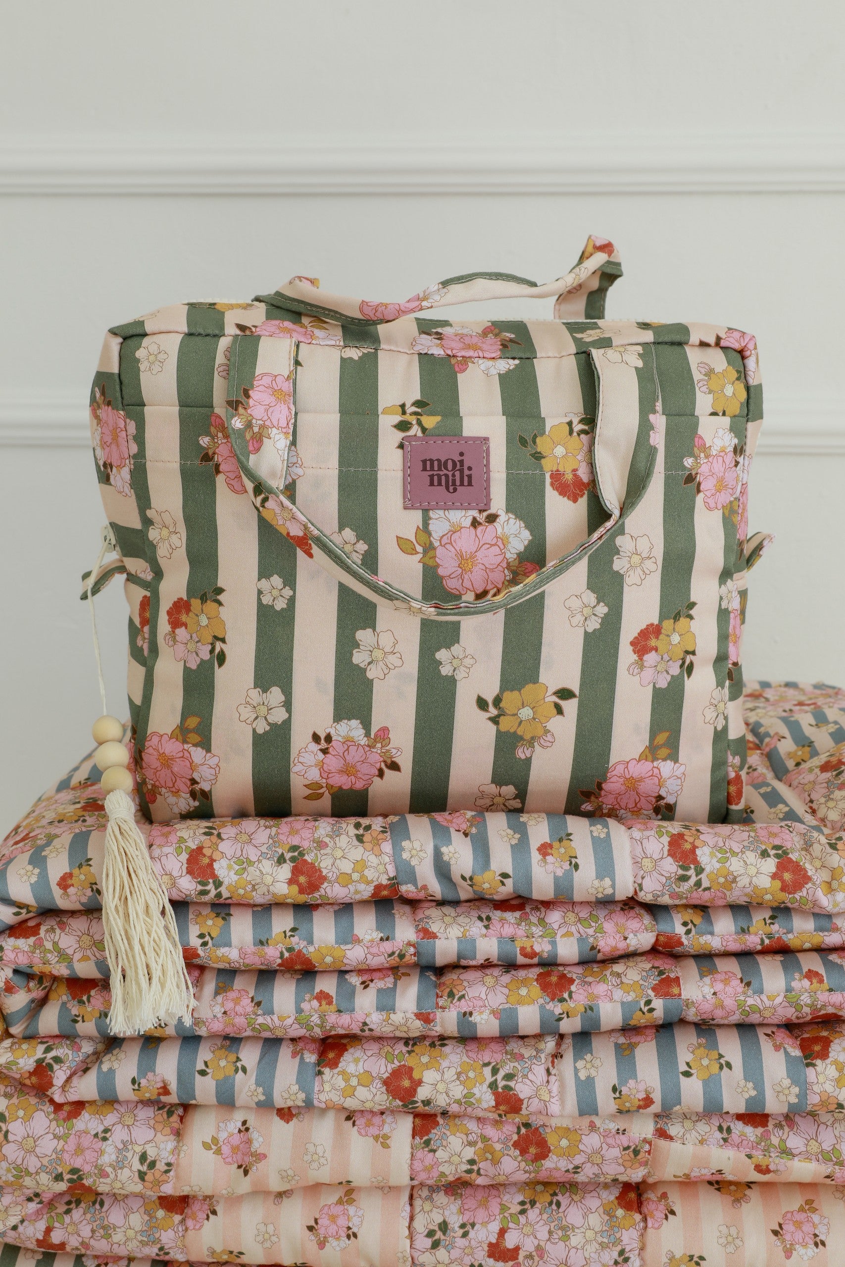 open chic green striped makeup bag showing its inner waterproof lining and organizational pockets
