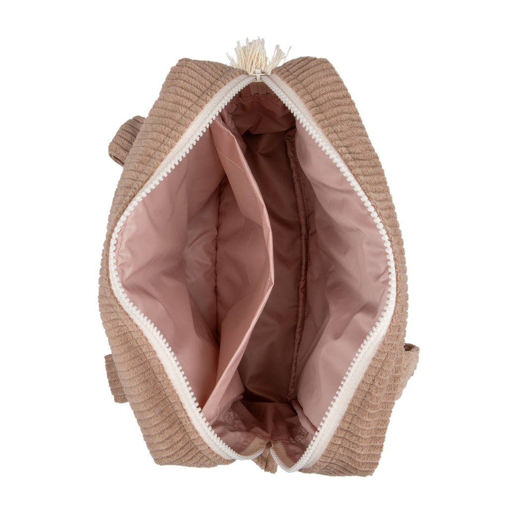 soft latte-colored makeup bag with cotton texture, open to show spacious interior and pockets, resting on a cozy linen backdrop
